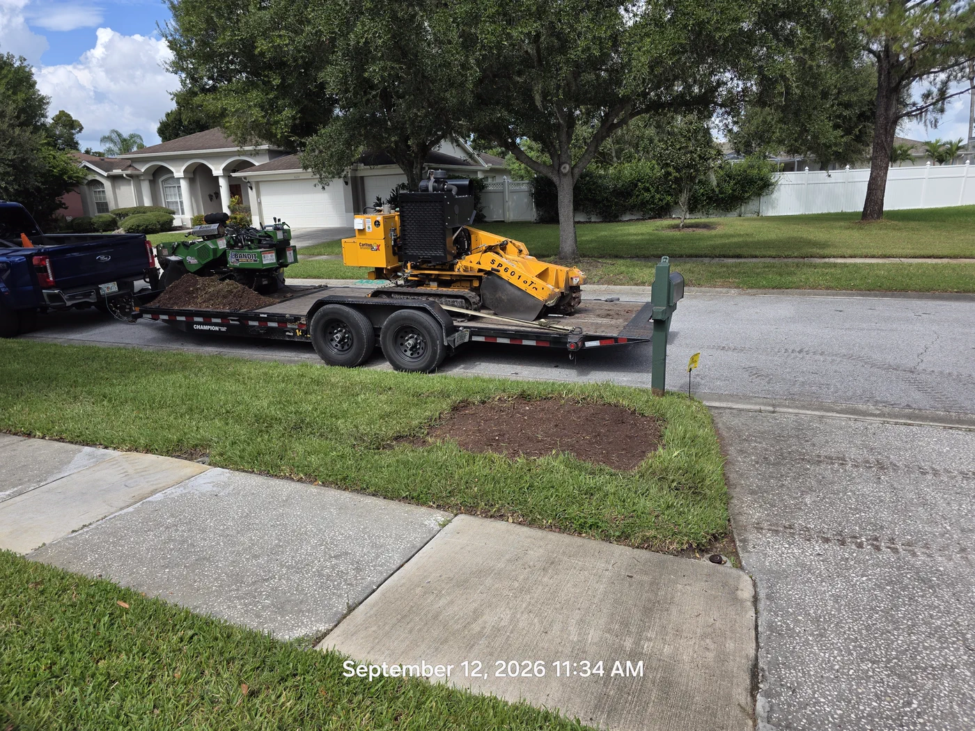 Stump ground flush and equipment loaded after a Tampa stump grinding job
